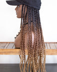 Mannequin with a Coils to Locs kimmie cap braids in dark brown golden ombre, side view.