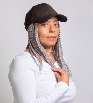 black woman wearing kimmie cap short braids grey