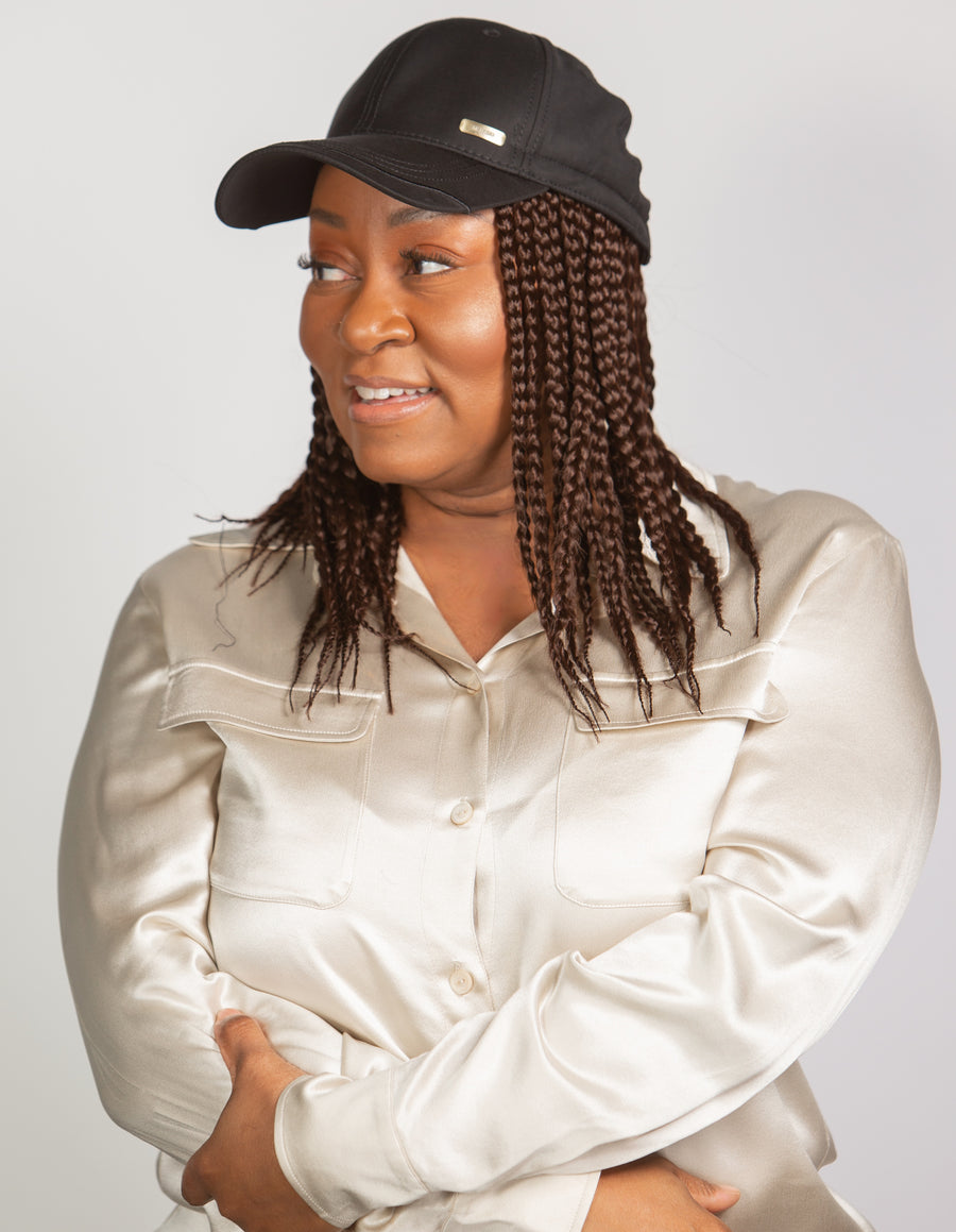 black woman wearing kimmie cap brown short braids