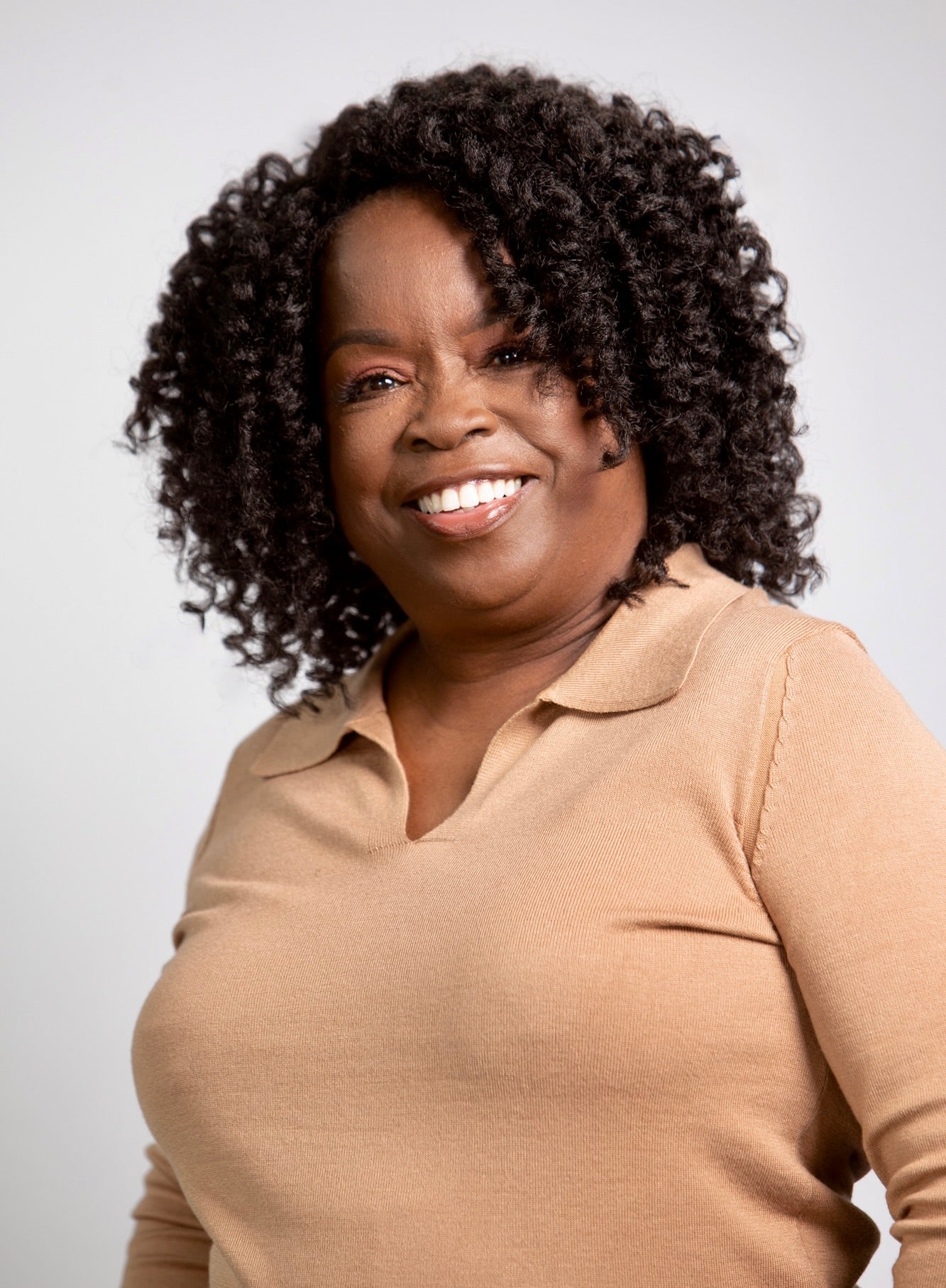 Coils to Locs Cleo wig with soft perm rod curls in dark brown, front view.