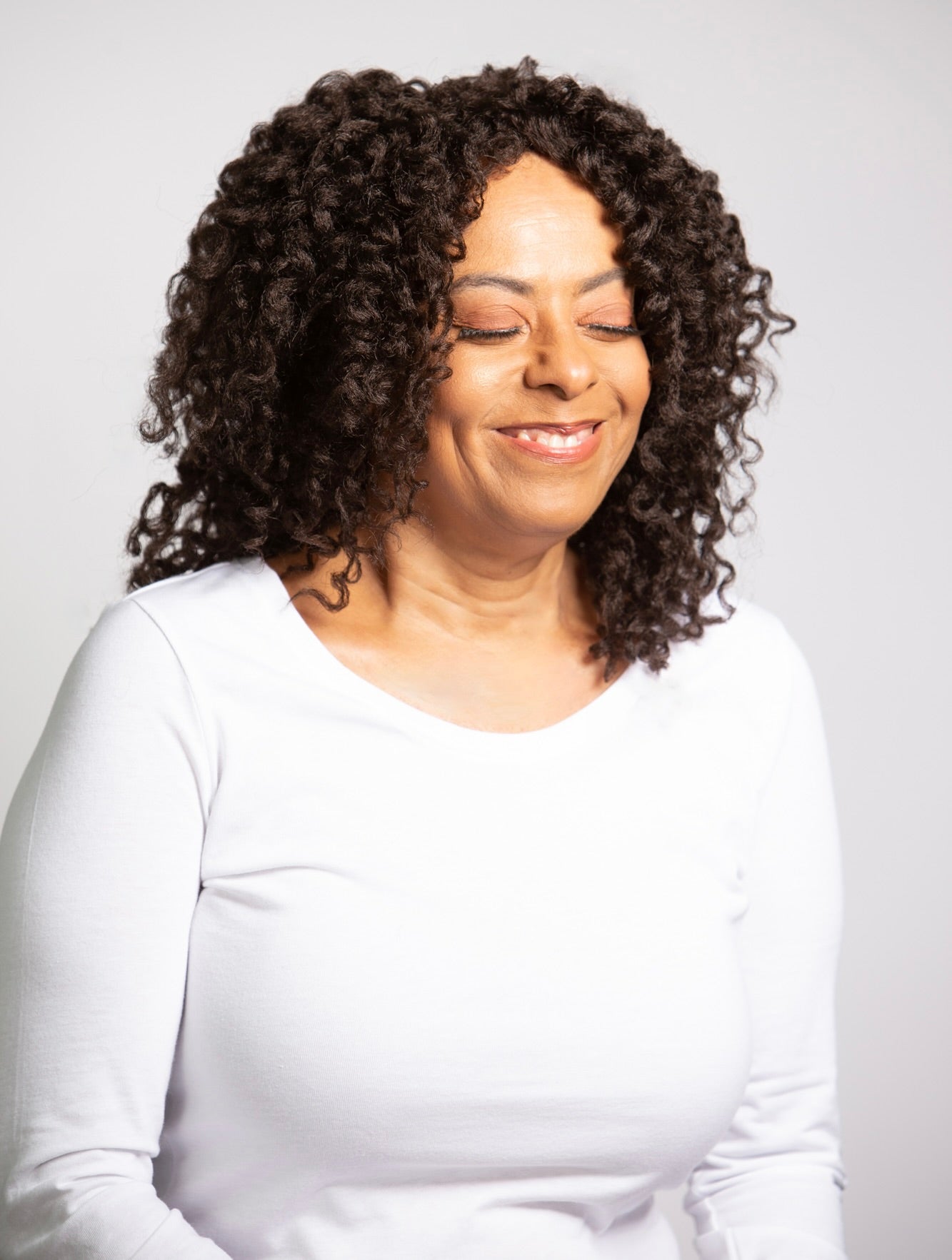 Coils to Locs shoulder length Cleo wig in dark brown with soft perm rod curls, front view.