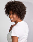 Black woman wearing Coils to Locs Ashanti synthetic wig in dark brown.
