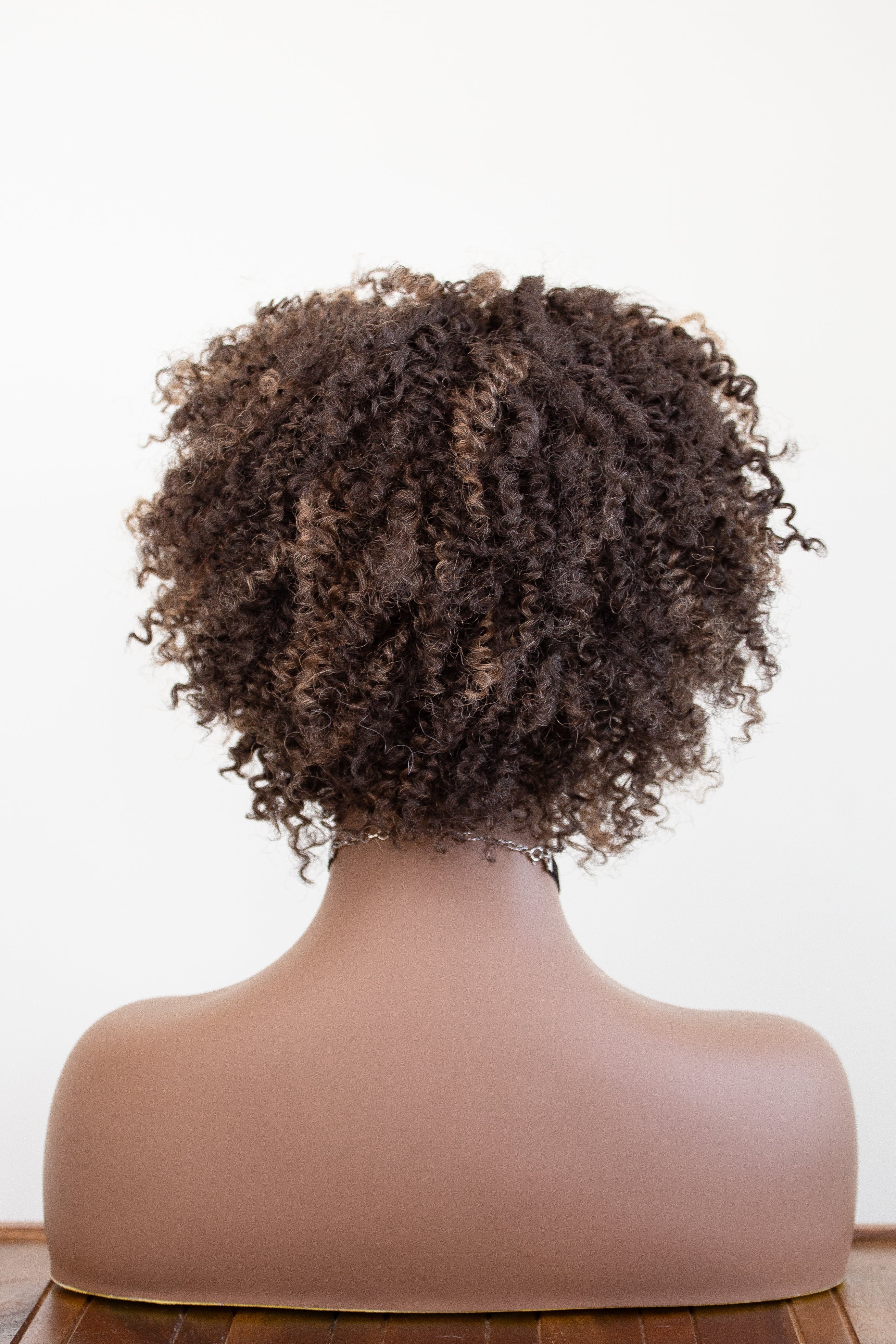 back view of Coils to Locs ashanti wig, brown with golden highlights.