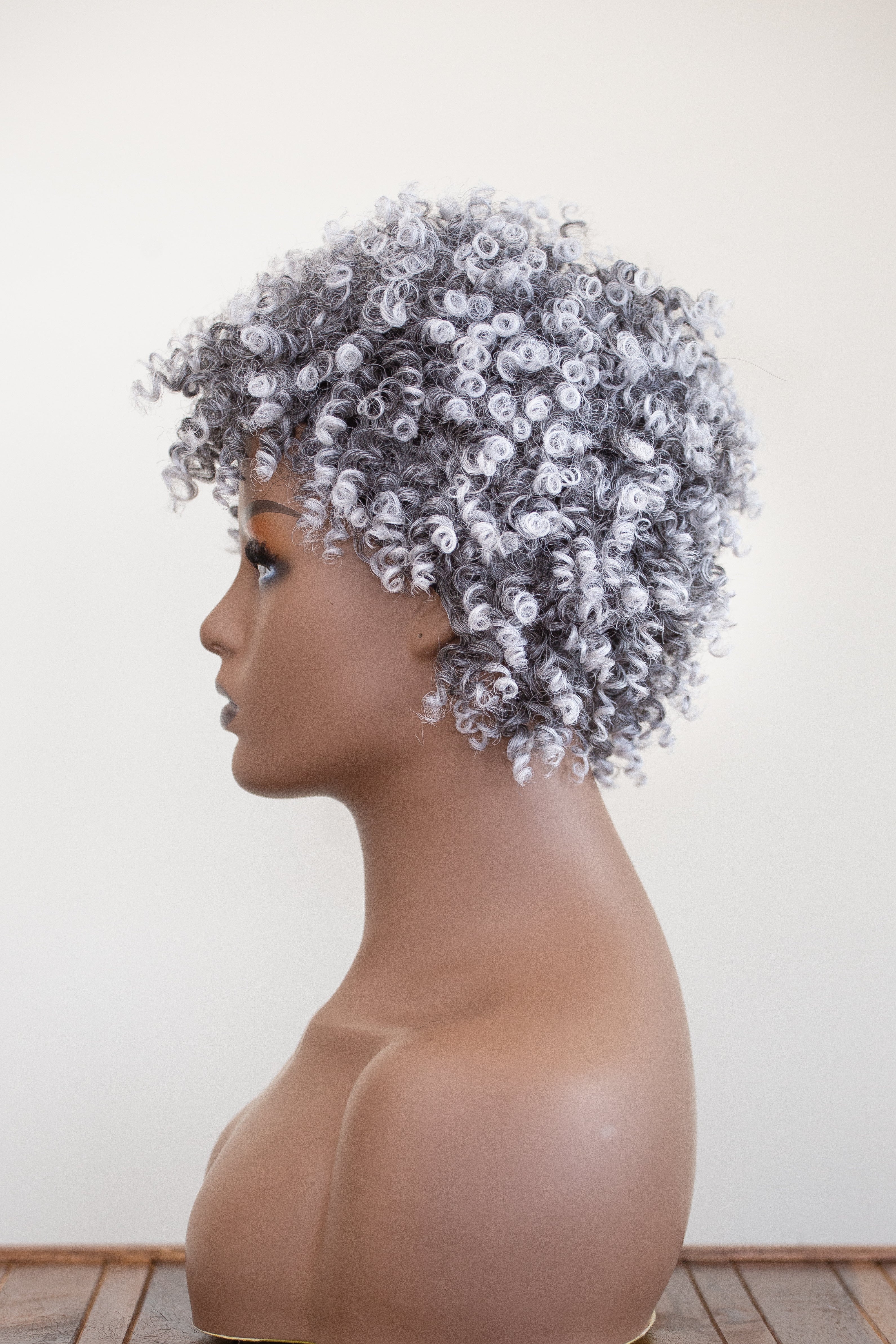 Coils to Locs Jasmine onxy (salt and pepper)) wig on mannequin. Side view.