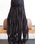 Mannequin wearing a Coils to Locs kimmie cap black hair braids back view.