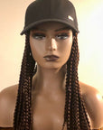 Mannequin with a Coils to Locs kimmie cap braids in brown front view.